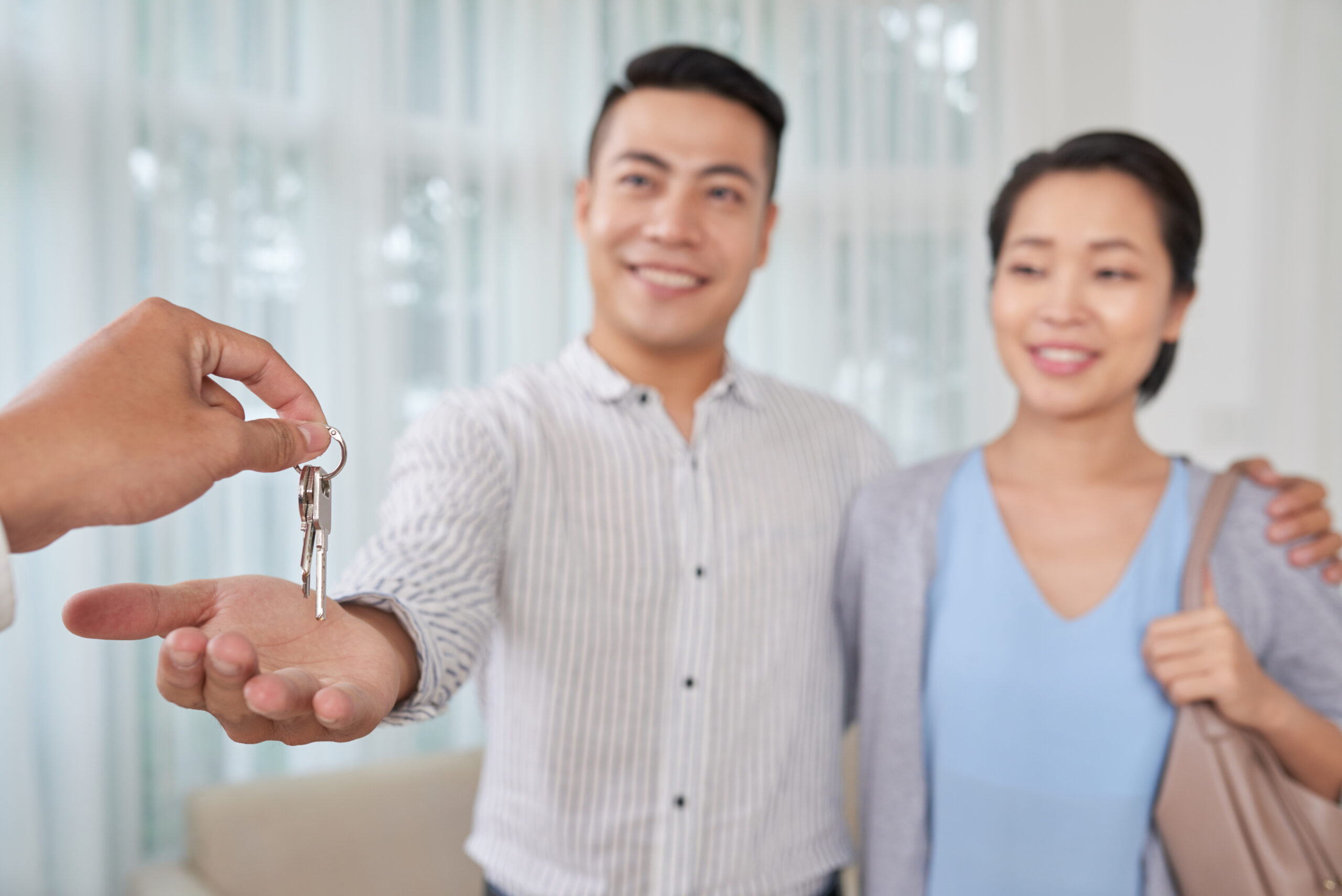 a couple receiving the keys to their house