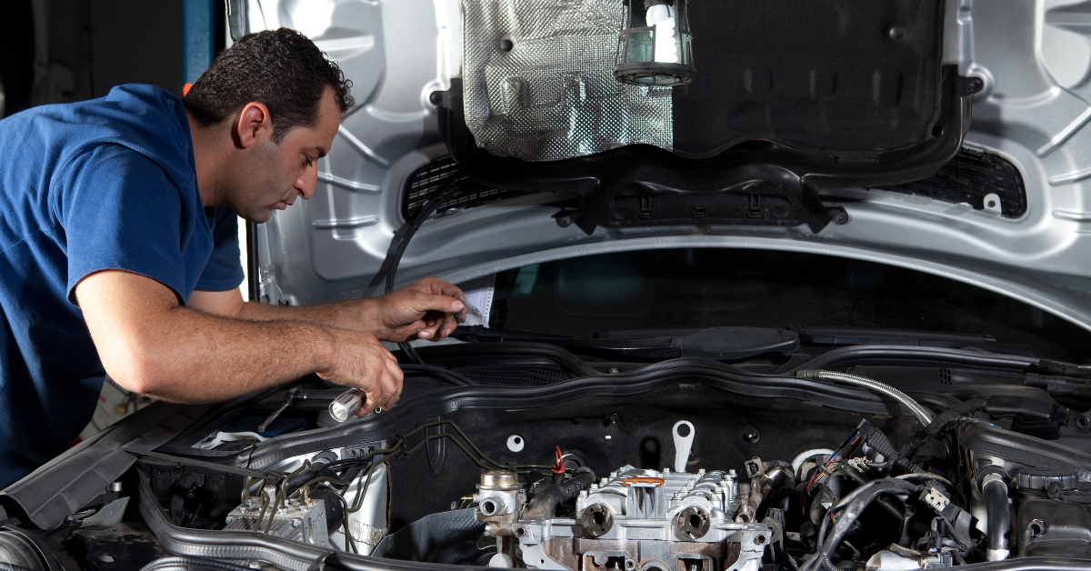 a car technician working on the engine
