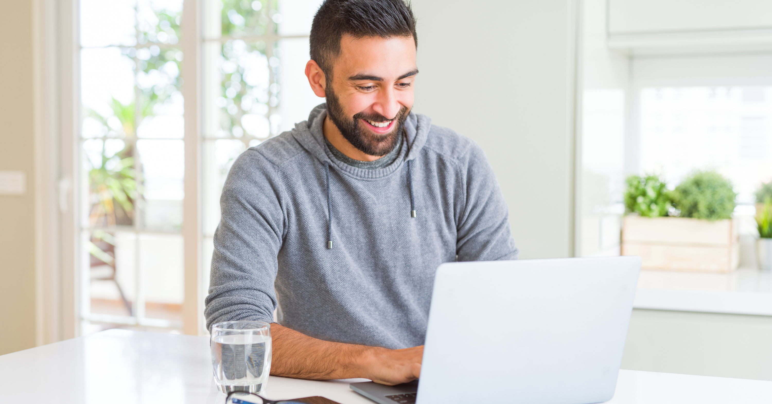 man smiling at his computer