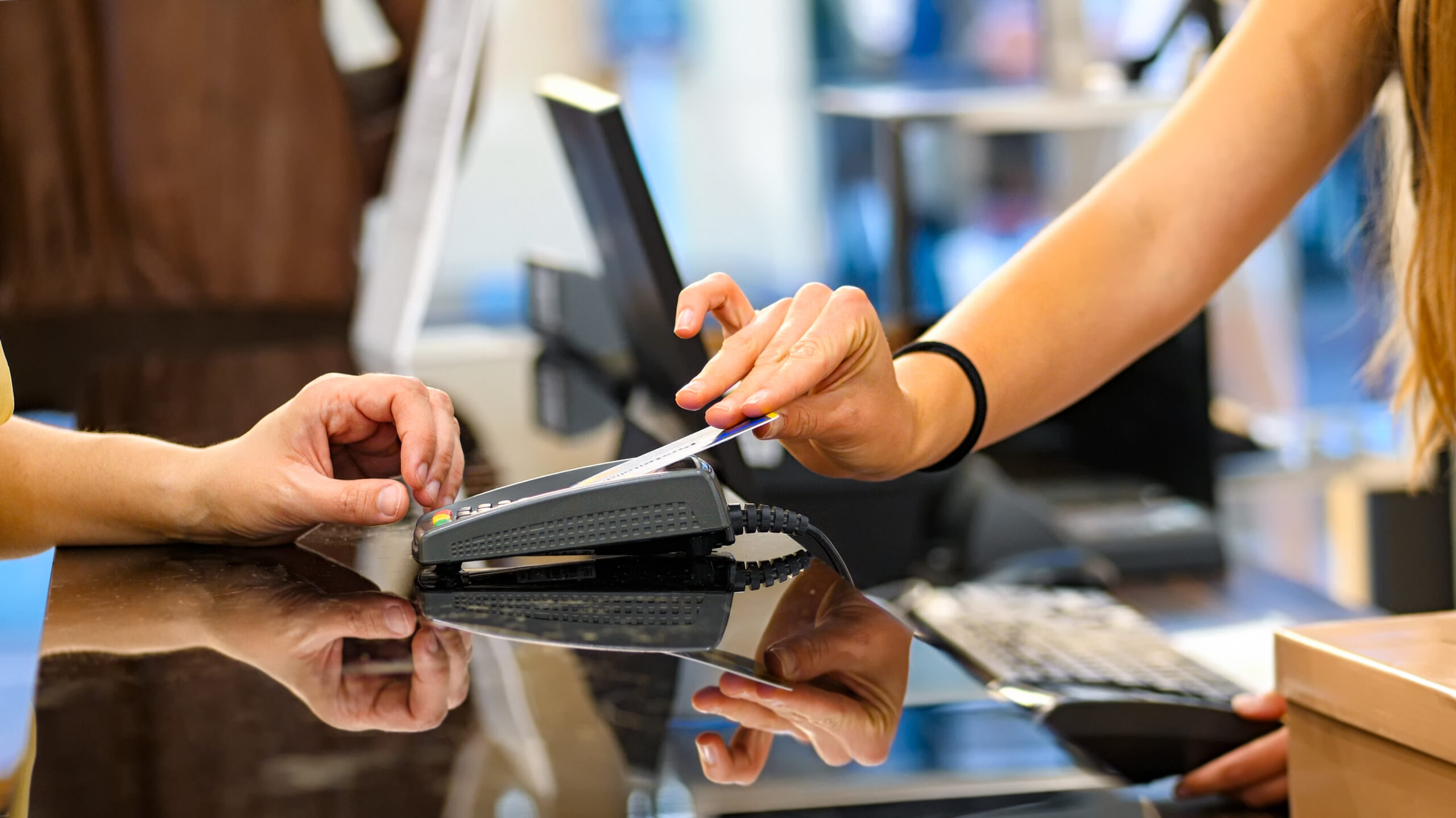 a woman paying with a credit card