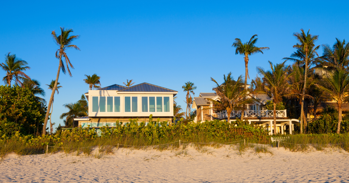 a beach house surrounded by palm trees