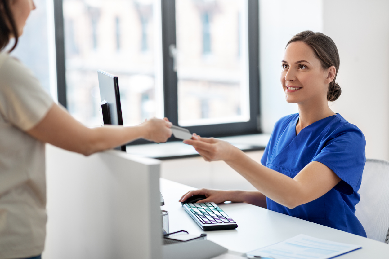 a medical assistant accepting a credit card payment