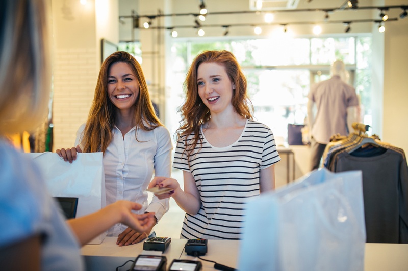 two women paying at a store