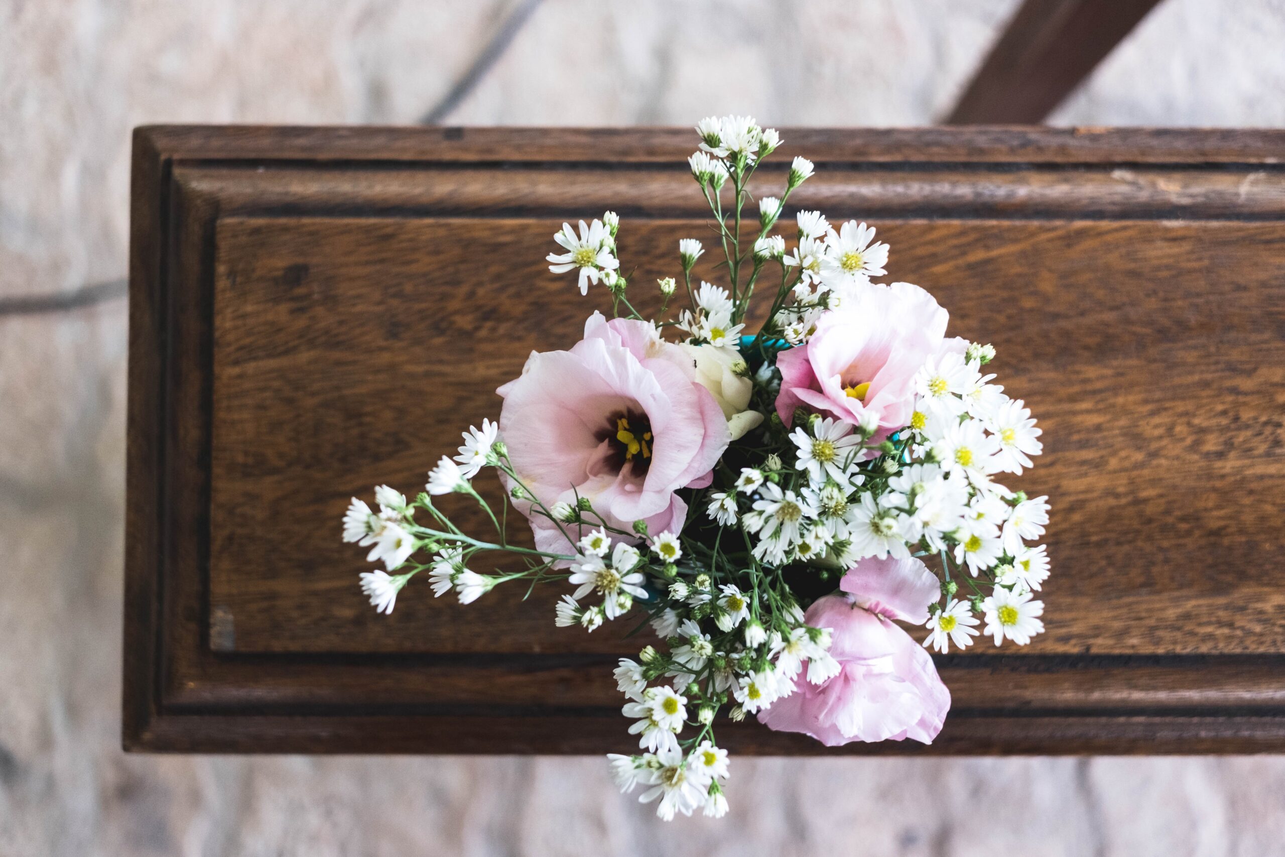 pink and white flowers on a wooden table