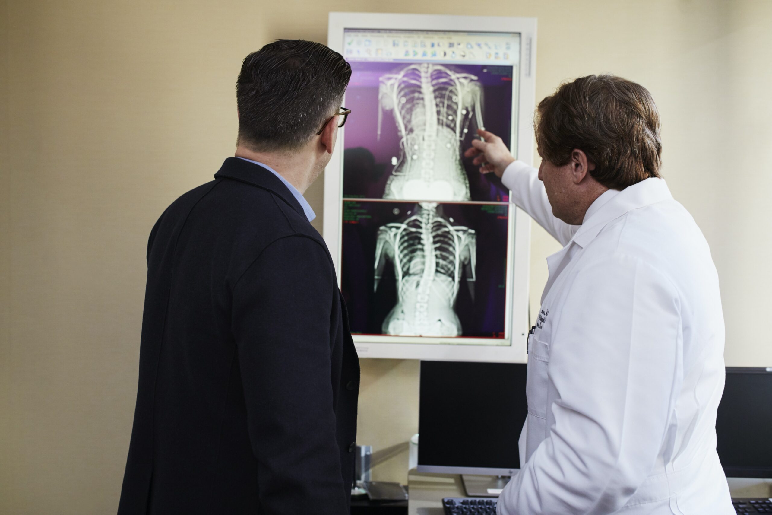 a doctor and his patient looking at x-ray scans