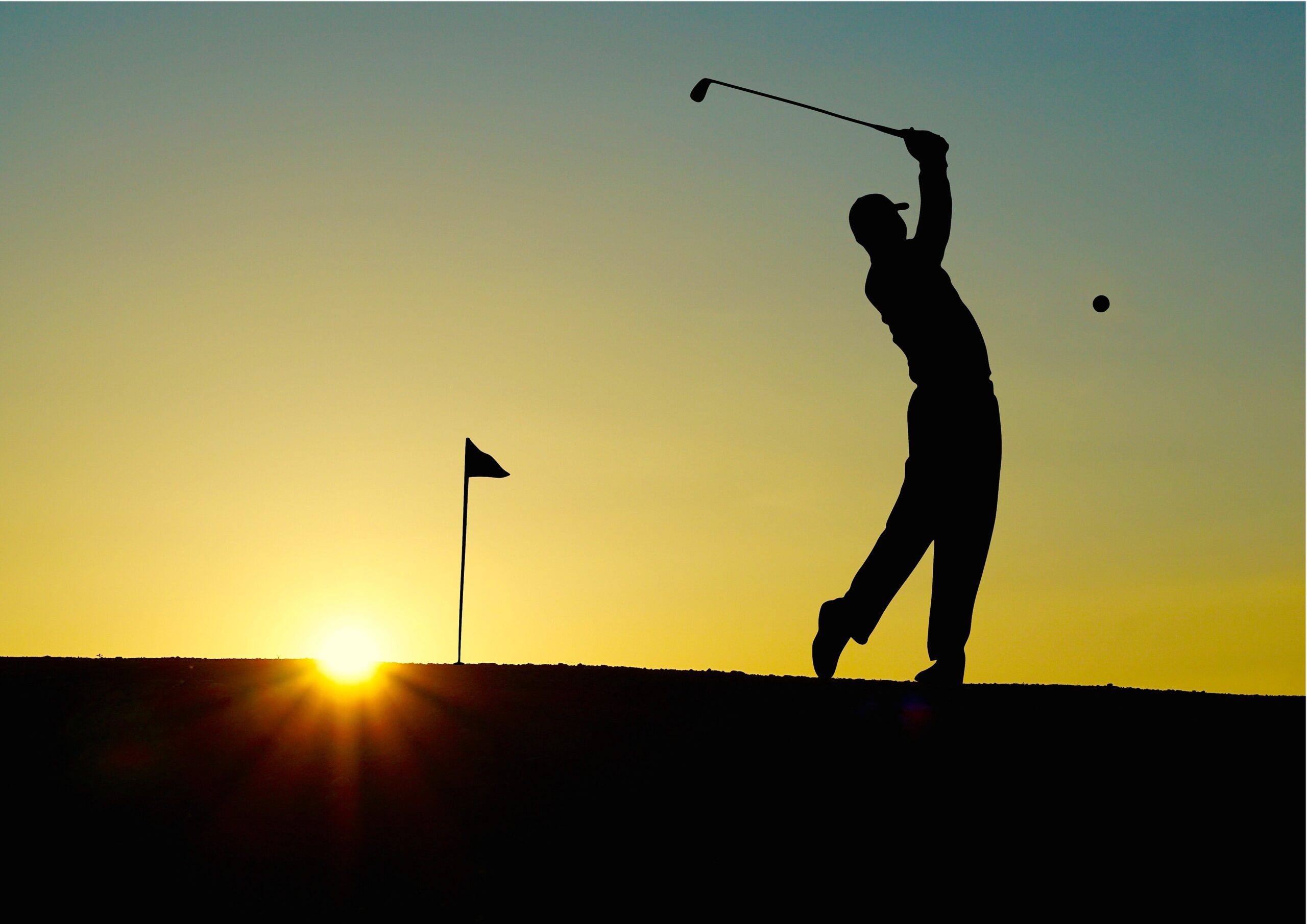 someone golfing at sunset