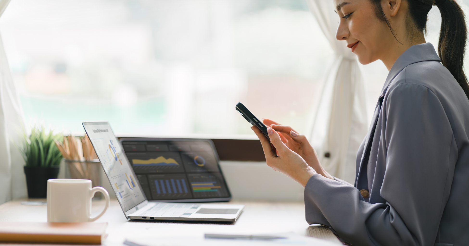 Independent sales woman working on phone and laptop