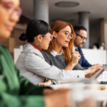 Diverse Team Collaborating During Professional Office Meeting With Documents